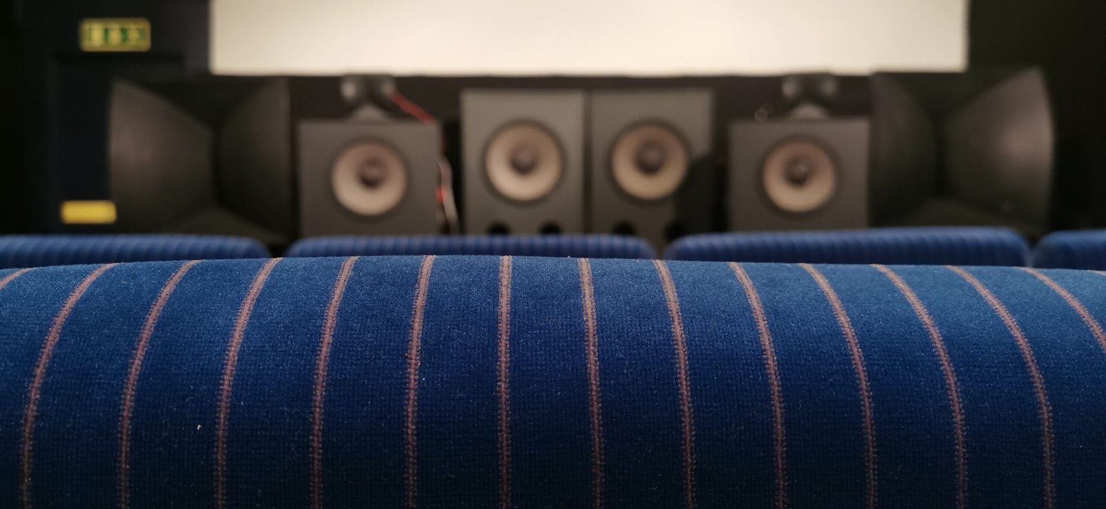Hypnos Theatre's vintage cinema chairs and JBL speaker array.